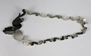 Silver necklace with abstract design pattern.