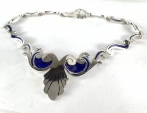Silver necklace with blue enamel accents.
