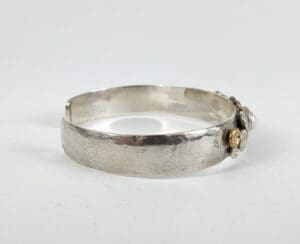 Silver bracelet with decorative embellishments.