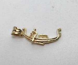 Gold pendant shaped like a gondola.