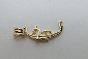 Gold pendant with abstract design.