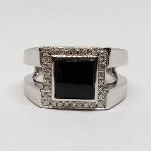 Silver ring with black square stone.