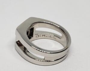 Silver geometric ring with cut-out design.