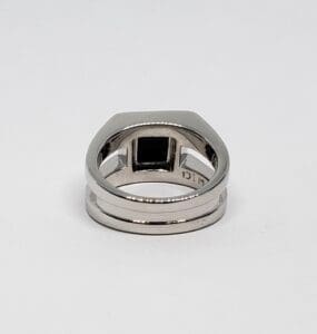 Silver ring with black square gemstone.