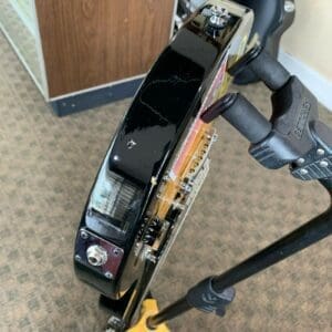 Electric guitar on stand, viewed from side.