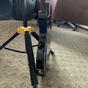 Electric guitar on stand in office.