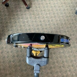 Electric guitar on stand, viewed from top.
