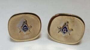 Gold cufflinks with Masonic symbol design.