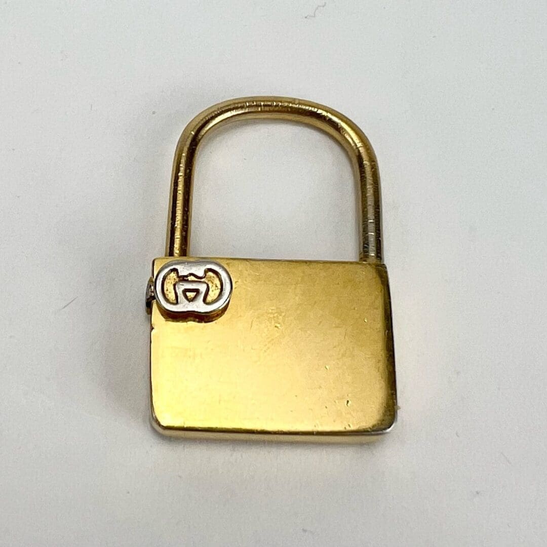 Gold padlock with a small logo.
