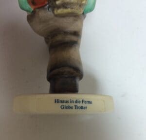 Figurine base with German text inscription.