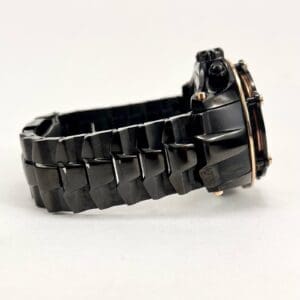 Black watch with textured metal strap.