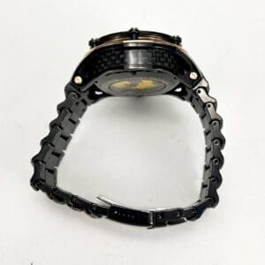 Black metal wristwatch with linked strap.