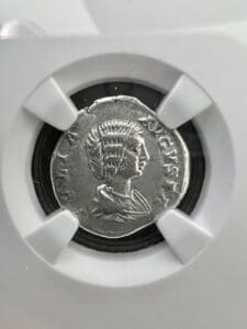 Ancient coin with profile of a figure.