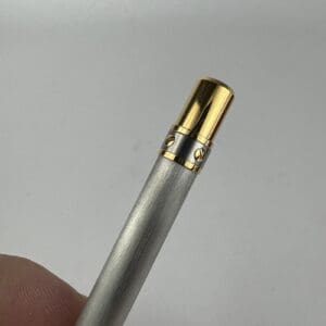 Metallic pen with gold accents, close-up.