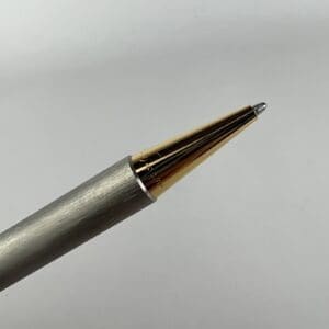 Metallic pen tip on white background.