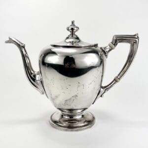 Silver teapot with elegant curved handle.