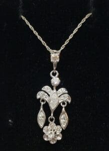 Elegant diamond pendant on black background.