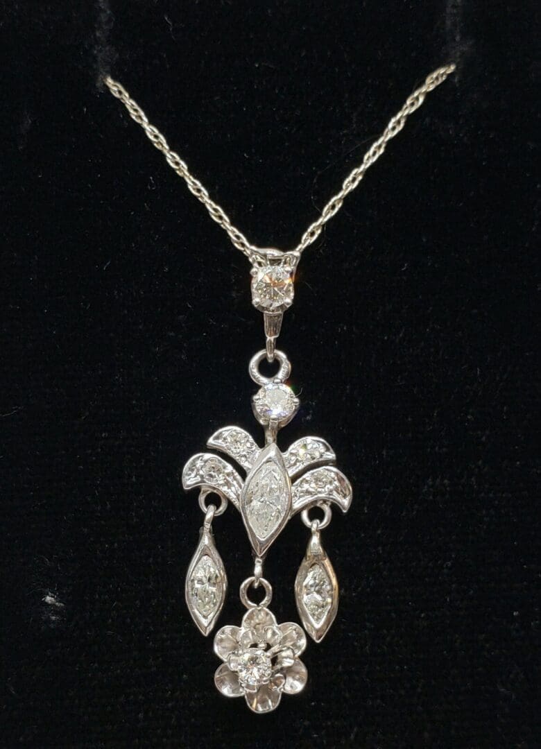 Elegant diamond pendant on black background.