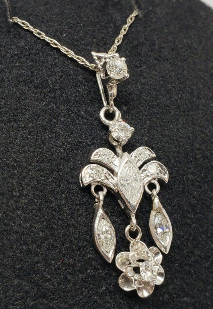 Elegant silver pendant with intricate floral design.