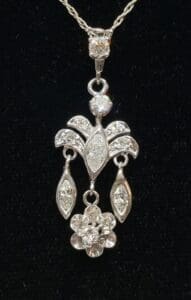 Elegant diamond pendant on black background.