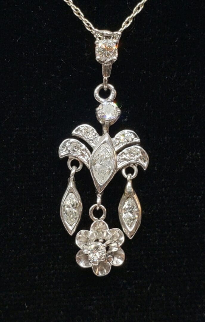 Elegant diamond pendant on black background.