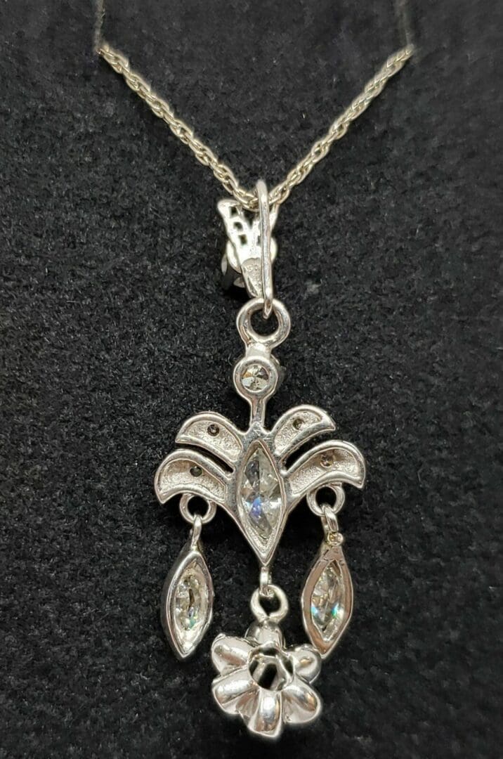Ornate silver pendant with gemstone accents.