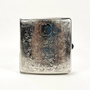 Ornate silver cigarette case with intricate engraving.