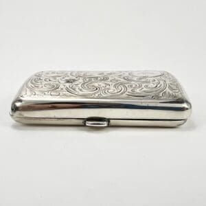Ornate silver cigarette case with engravings.