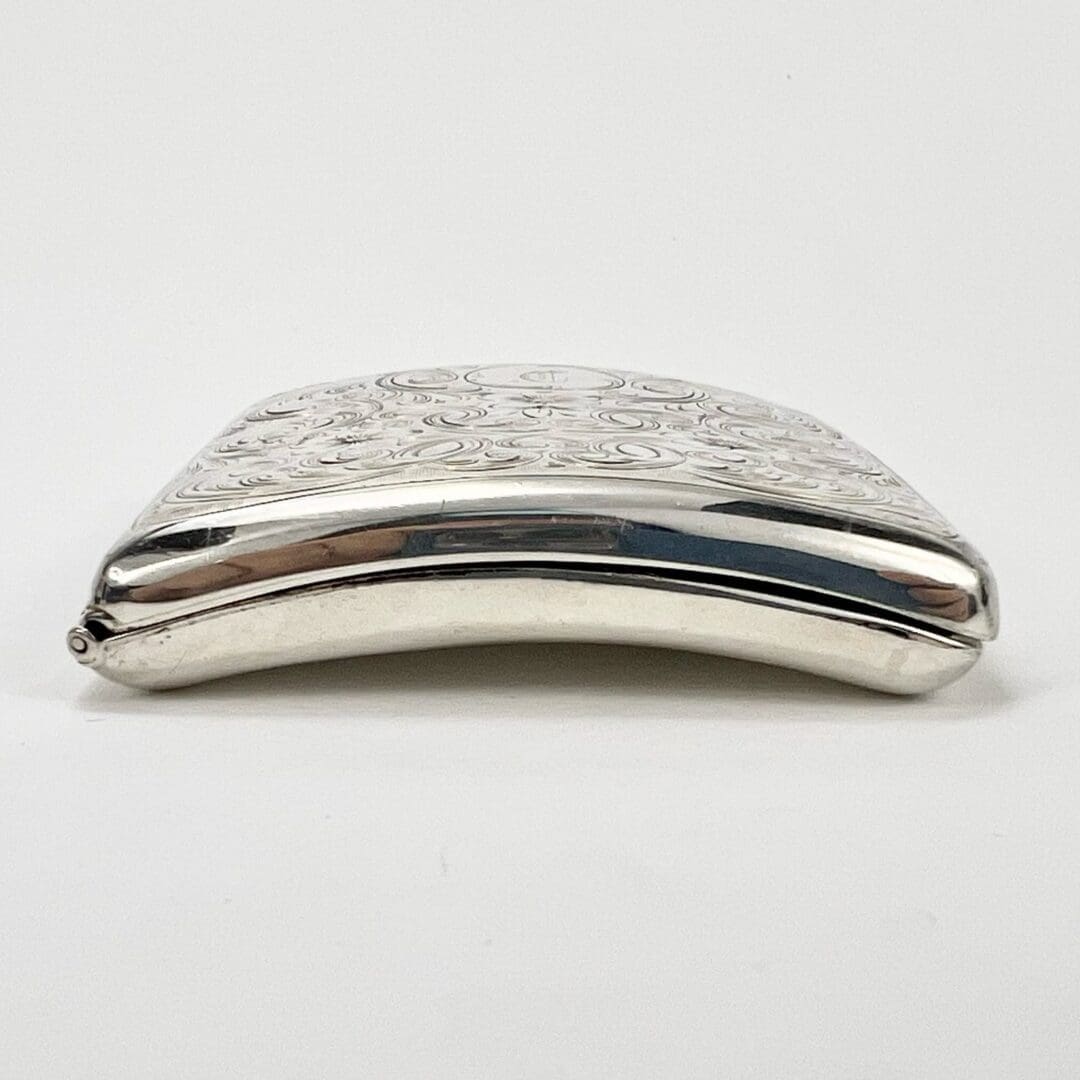 Silver decorative metal case with embossed design.
