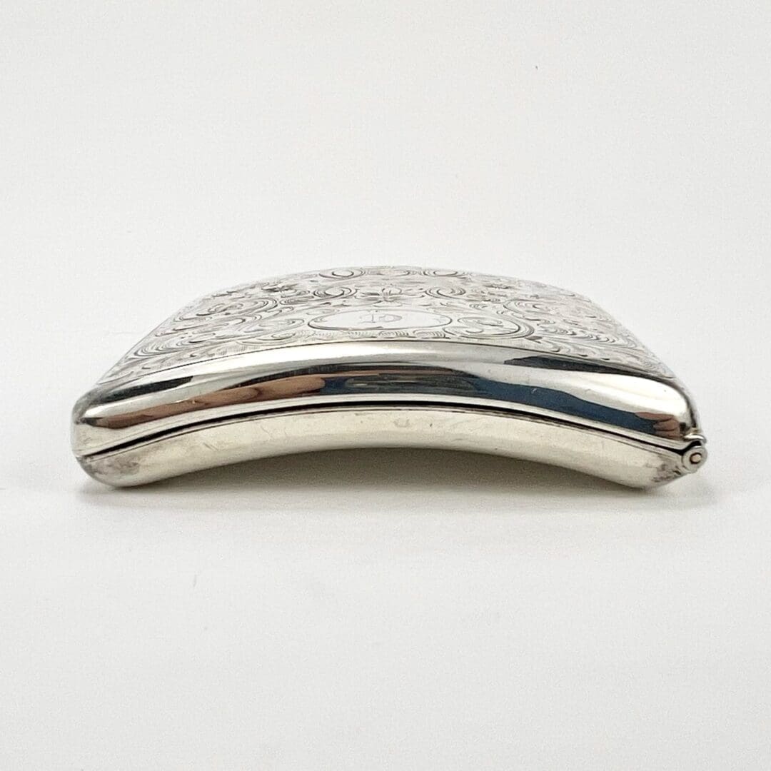 Ornate silver cigarette case on white background.