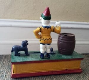 Colorful vintage toy with figure and barrel.