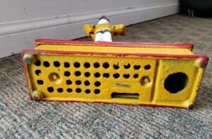 Colorful vintage toy on carpeted floor.