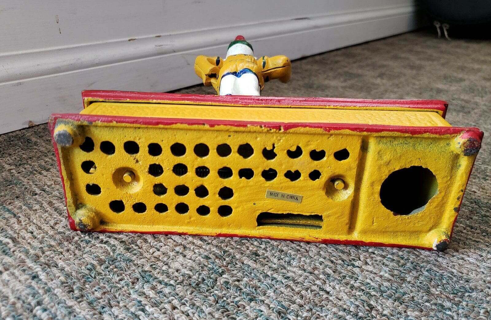Colorful vintage toy on carpeted floor.
