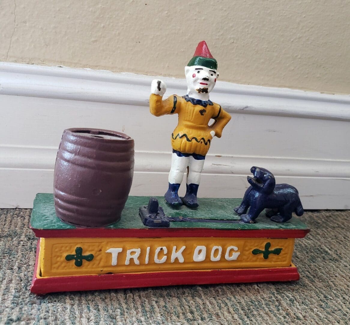 Toy clown and dog on colorful base.