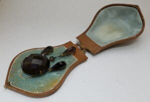 Jewelry set in an open brown case.