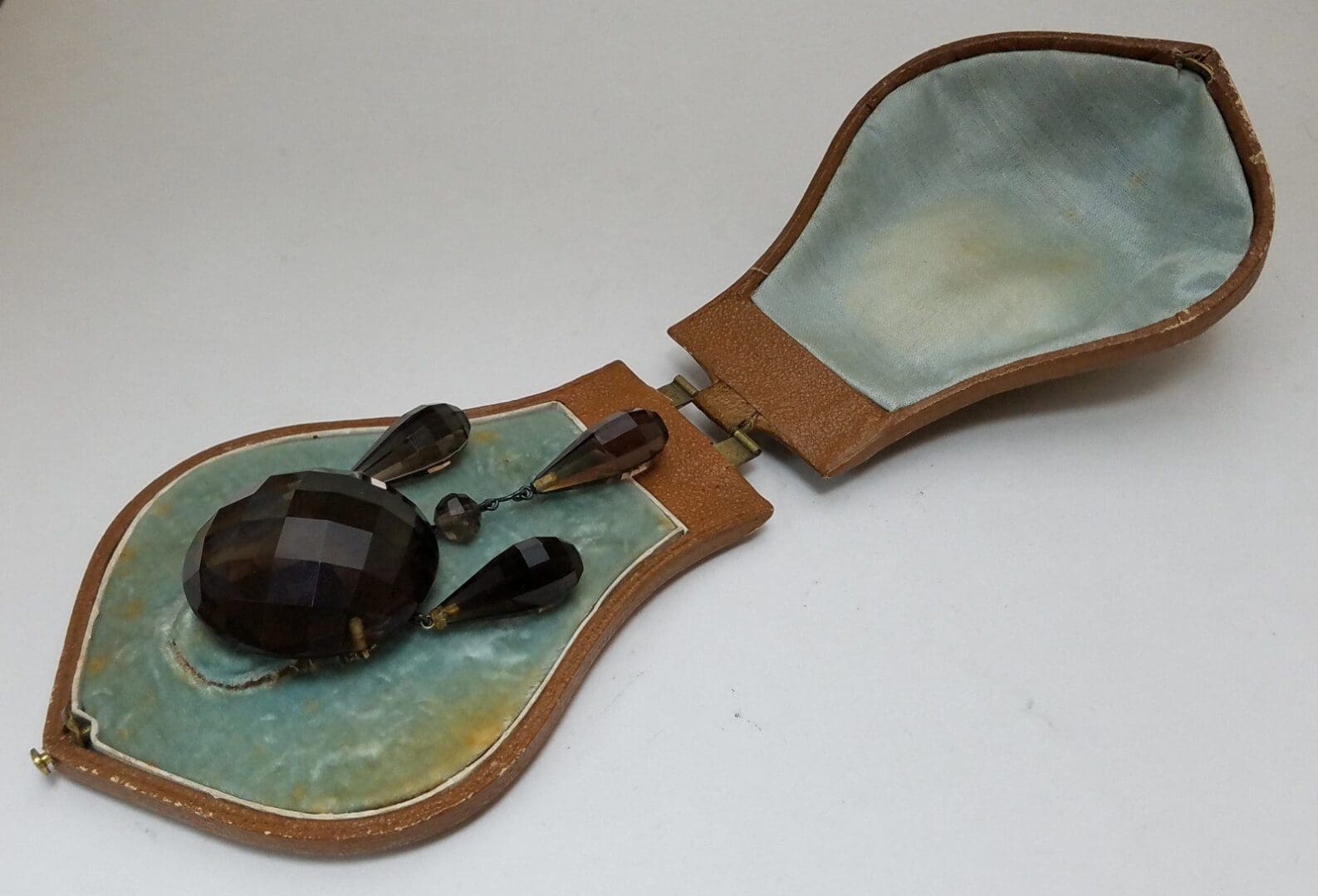 Jewelry set in an open brown case.