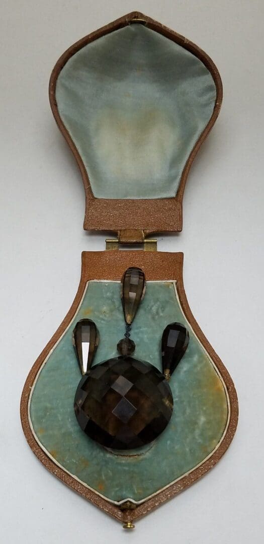 Jewelry piece in an open case.
