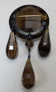 Vintage brooch with faceted brown glass pendants.