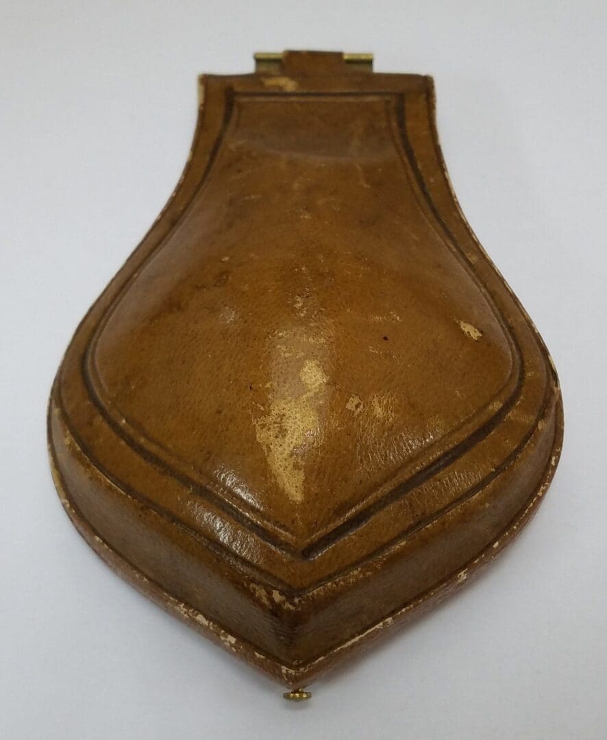 Brown leather pouch with a hinged clasp.