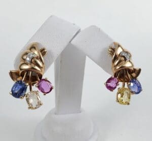 Gold earrings with colorful gemstone dangles.