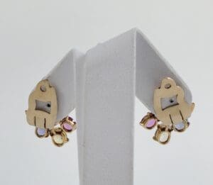 Gold earrings with colorful gem accents.