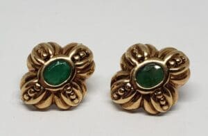 Gold earrings with green stone center.