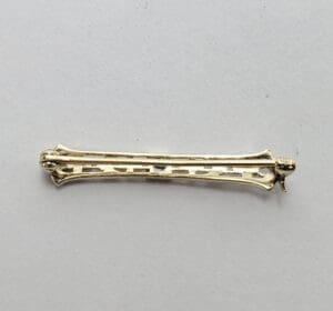 Gold hair clip on white background.