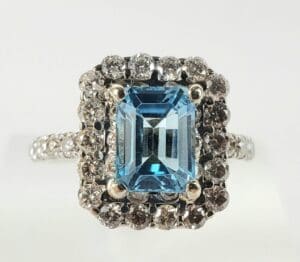 Blue gemstone ring with diamond accents.