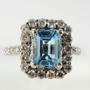 Blue gemstone ring with diamond accents.