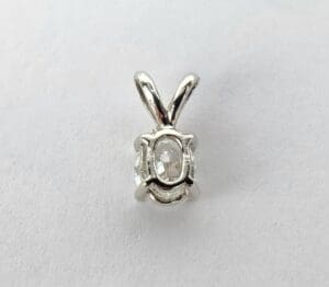 Silver pendant with oval diamond setting.