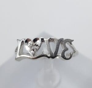 Silver ring with "LOVE" design.