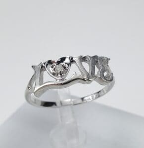 Silver ring with heart and "LOVE" design.