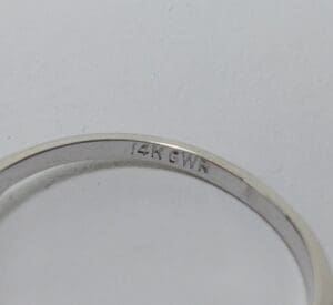 14K white gold ring engraving close-up.