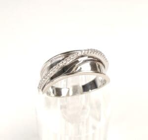 Silver ring with intertwined band design.